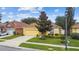 Well-manicured single-Gathering home with a two-car garage, green lawn, and mature landscaping at 1041 Cherry Valley Way, Orlando, FL 32828