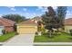 Charming single-Gathering home with a well-maintained lawn, mature landscaping, and a two-car garage at 1041 Cherry Valley Way, Orlando, FL 32828