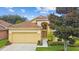 Inviting single-Gathering home with manicured lawn, mature landscaping, and a convenient two-car garage at 1041 Cherry Valley Way, Orlando, FL 32828