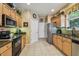 Functional kitchen with stainless appliances and backsplash, and beautiful wall decor at 1041 Cherry Valley Way, Orlando, FL 32828