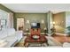 Inviting living room with hardwood floors, green walls, and an elegant coffee table at 1041 Cherry Valley Way, Orlando, FL 32828