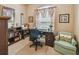Well-lit office space with a comfortable chair, wooden desk, and bookshelf storage at 1041 Cherry Valley Way, Orlando, FL 32828