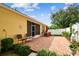 Brick patio with outdoor seating and a peaceful garden view at 1041 Cherry Valley Way, Orlando, FL 32828