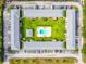 Bird's eye view of apartment complex featuring a landscaped courtyard with a central swimming pool and ample parking at 1100 E Caroline St # 204, Tavares, FL 32778