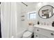 This bathroom features a vanity with marble countertop and an enclosed shower/tub at 1100 E Caroline St # 204, Tavares, FL 32778