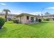 Exterior view of the community clubhouse surrounded by lush landscaping at 1100 E Caroline St # 204, Tavares, FL 32778