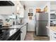 Well-lit kitchen featuring stainless steel refrigerator and granite countertops at 1100 E Caroline St # 204, Tavares, FL 32778