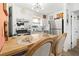 Contemporary kitchen with stainless steel appliances, granite counters, and an adjacent dining area, great for entertaining at 1100 E Caroline St # 204, Tavares, FL 32778