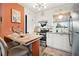 Modern kitchen features stainless steel appliances, granite countertops, and an eat-in breakfast bar, ideal for cooking at 1100 E Caroline St # 204, Tavares, FL 32778