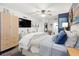 Comfortable main bedroom with a TV, a queen bed, a ceiling fan, and a dresser at 1100 E Caroline St # 204, Tavares, FL 32778