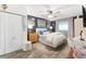 Comfortable main bedroom with a ceiling fan, a queen bed, and a large area rug at 1100 E Caroline St # 204, Tavares, FL 32778