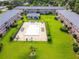 Aerial view of community pool surrounded by lush landscaping and well-maintained apartment buildings at 1100 E Caroline St # 204, Tavares, FL 32778
