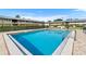 Community pool with manicured landscaping and multiple apartment buildings at 1100 E Caroline St # 204, Tavares, FL 32778