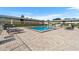 The community pool surrounded by lounge chairs and manicured landscaping at 1100 E Caroline St # 204, Tavares, FL 32778