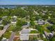 An aerial view of a serene, tree-lined neighborhood featuring houses with pools and beautiful landscaping at 1115 Naples Dr, Orlando, FL 32804
