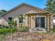 Backyard view with pergola and sliding glass door entry, offering indoor-outdoor living at 1115 Naples Dr, Orlando, FL 32804