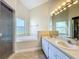 This bathroom features double sinks, a garden tub, and a privacy window at 1115 Naples Dr, Orlando, FL 32804