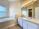 Bathroom has double sinks, a bright light fixture, and a large garden tub at 1115 Naples Dr, Orlando, FL 32804