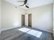 This bedroom offers neutral walls, gray flooring, a ceiling fan and closet at 1115 Naples Dr, Orlando, FL 32804