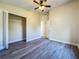 This bedroom features neutral paint, gray floors, and a closet space at 1115 Naples Dr, Orlando, FL 32804