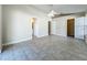 Spacious bedroom with tile flooring, ceiling fan, and access to a bathroom and walk-in closet at 1115 Naples Dr, Orlando, FL 32804