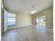 Large bedroom featuring tile flooring, a window, and a sliding glass door to the outside at 1115 Naples Dr, Orlando, FL 32804