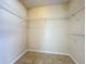 Walk-in closet with tile floors and wire shelving for optimal storage at 1115 Naples Dr, Orlando, FL 32804