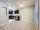 Inviting dining area next to an updated kitchen with dark wood cabinets and tile flooring at 1115 Naples Dr, Orlando, FL 32804