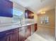 Modern kitchen with quartz countertops, dark cabinets, and stainless steel appliances, including a dishwasher at 1115 Naples Dr, Orlando, FL 32804