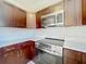 Close-up of updated kitchen featuring stainless steel microwave, stove and dark cabinetry at 1115 Naples Dr, Orlando, FL 32804