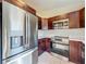Kitchen showcasing stainless steel refrigerator, microwave, and stove, paired with sleek countertops at 1115 Naples Dr, Orlando, FL 32804