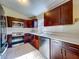 Updated kitchen with stainless steel appliances, dark wood cabinets, and quartz countertops at 1115 Naples Dr, Orlando, FL 32804