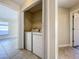 This laundry room has a washer and dryer behind folding closet doors at 1115 Naples Dr, Orlando, FL 32804