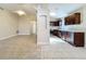 Spacious living room flowing into an updated kitchen, featuring tile floors and neutral paint at 1115 Naples Dr, Orlando, FL 32804