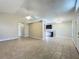 Open-concept living room with tile flooring, a ceiling fan, and a partial view of the kitchen at 1115 Naples Dr, Orlando, FL 32804
