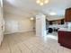 Open-concept living and kitchen area with tile flooring and modern stainless steel appliances at 1115 Naples Dr, Orlando, FL 32804