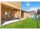 A cozy backyard featuring a covered patio, green lawn, a slide, and a swing set at 12255 Joshua Tree Trl, Windermere, FL 34786