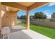 A spacious outdoor covered patio extending to a vibrant green yard with a swing set at 12255 Joshua Tree Trl, Windermere, FL 34786