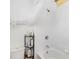 Bathroom with white tiling, a bathtub and shower combination, and a toiletries shelf at 12255 Joshua Tree Trl, Windermere, FL 34786