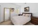 A bedroom features a cozy queen bed with neutral bedding and matching bedside tables at 12255 Joshua Tree Trl, Windermere, FL 34786