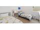 A bright bedroom with two twin beds with patterned bedding and a window for natural light at 12255 Joshua Tree Trl, Windermere, FL 34786