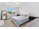 A bright bedroom with a queen bed, plush bedding and two side tables with drawers for storage at 12255 Joshua Tree Trl, Windermere, FL 34786