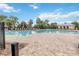 Large community pool with ample seating, set in a picturesque, tropical landscape at 12255 Joshua Tree Trl, Windermere, FL 34786