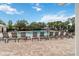 Inviting community pool area with numerous lounge chairs for relaxing by the water at 12255 Joshua Tree Trl, Windermere, FL 34786