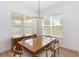 Dining room with hardwood floors, modern chandelier, and bright windows at 12255 Joshua Tree Trl, Windermere, FL 34786
