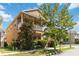 Two-story home boasts a second-floor balcony, mature trees, and manicured landscaping for curb appeal at 12255 Joshua Tree Trl, Windermere, FL 34786
