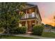 Two-story home featuring a front porch, balcony, and manicured shrubbery at 12255 Joshua Tree Trl, Windermere, FL 34786
