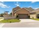 Suburban house featuring an attached garage and well-maintained lawn and landscaping at 12255 Joshua Tree Trl, Windermere, FL 34786