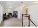 Upstairs loft area with carpet, natural light, and desk, adjacent to a staircase with wood railing at 12255 Joshua Tree Trl, Windermere, FL 34786