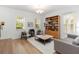 Bright living room showcases hardwood floors, large windows, and neutral decor at 12255 Joshua Tree Trl, Windermere, FL 34786